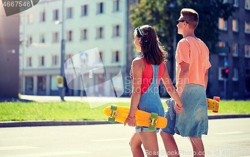 Image of teenage couple with skateboards on city crosswalk