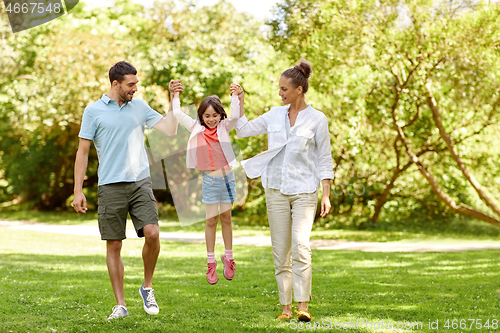 Image of happy family walking in summer park