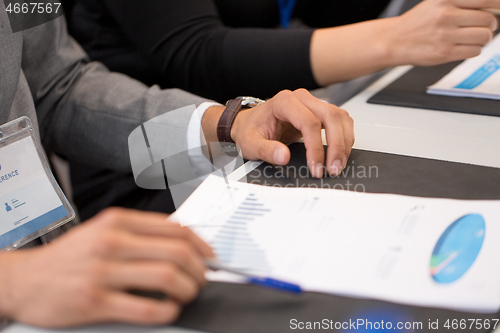 Image of hands of businessman at business conference