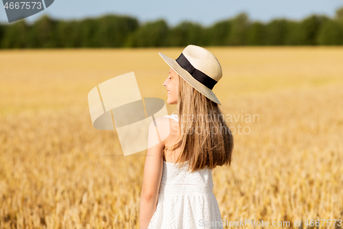 Image of portrait of girl in straw hat on field in summer