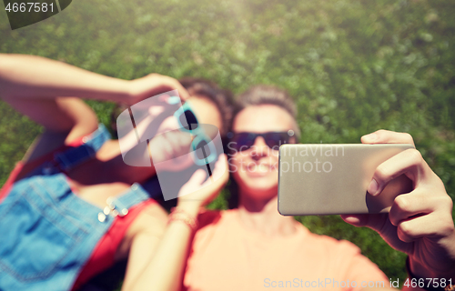 Image of happy couple taking selfie on smartphone at summer