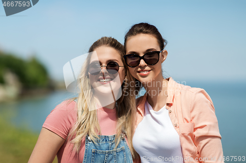 Image of teenage girls or best friends at seaside in summer