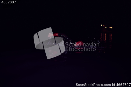 Image of triathlon athlete swimming in dark night wearing wetsuit