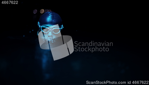 Image of authentic triathlete swimmer having a break during hard training on night neon gel light