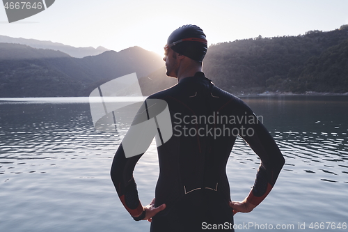 Image of triathlon athlete starting swimming training on lake