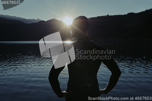 Image of triathlon athlete starting swimming training on lake