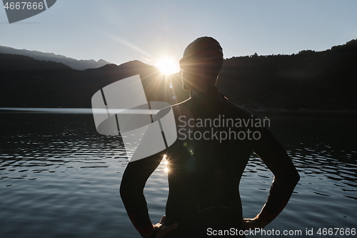 Image of triathlon athlete starting swimming training on lake