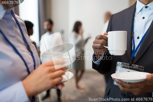 Image of business people with conference badges and coffee