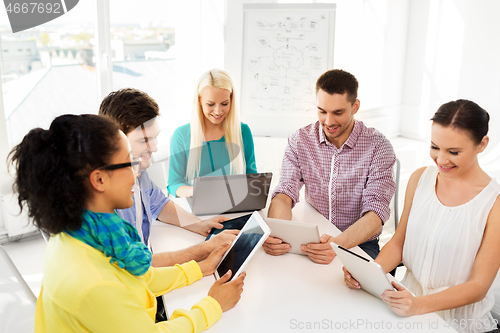 Image of creative team with table computers in office