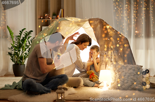 Image of father telling scary stories to his daughter