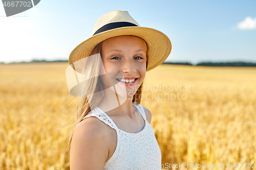 Image of portrait of girl in straw hat on field in summer