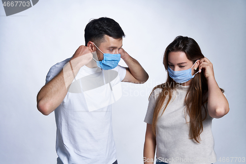 Image of Young couple wearing medicine masks