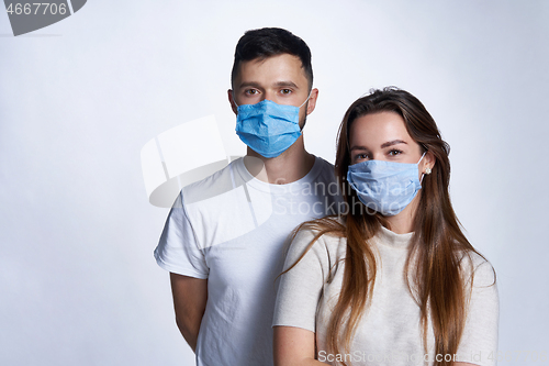 Image of Young couple wearing medicine masks