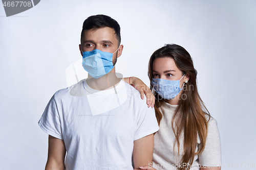 Image of Young couple wearing medicine masks