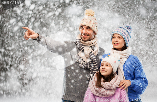 Image of happy family in winter clothes on snow background