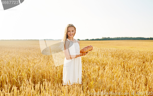 Image of girl with loaf of white bread on cereal field