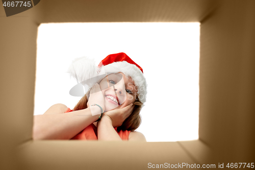 Image of amazed girl looking into christmas gift box