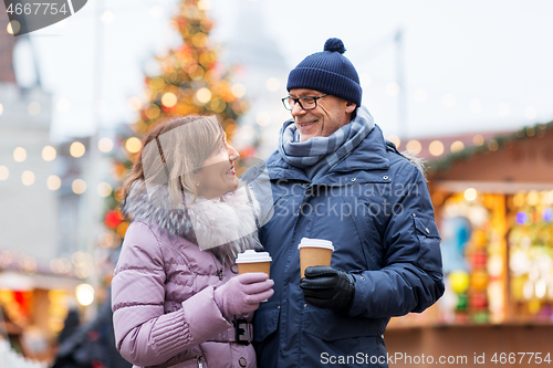 Image of senior couple with coffee at christmas market