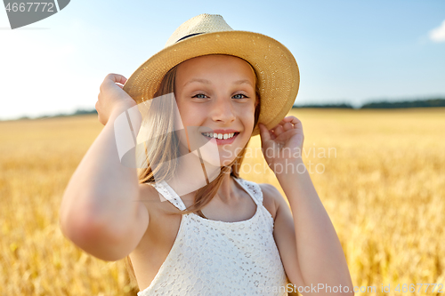 Image of portrait of girl in straw hat on field in summer