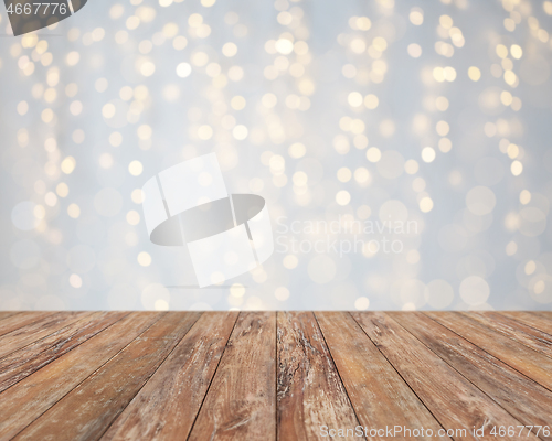 Image of empty wooden table with christmas golden lights