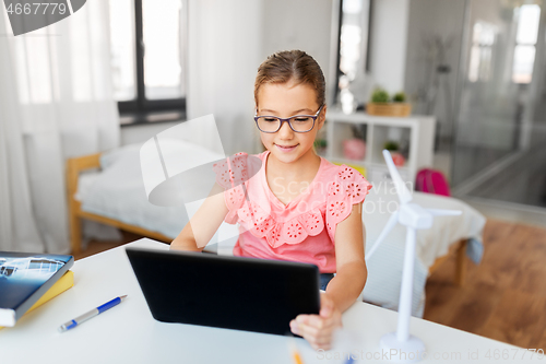 Image of student girl using tablet computer at home