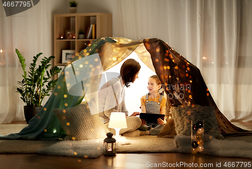 Image of family with tablet pc in kids tent at home