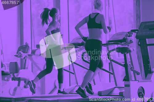 Image of woman exercising on treadmill in gym