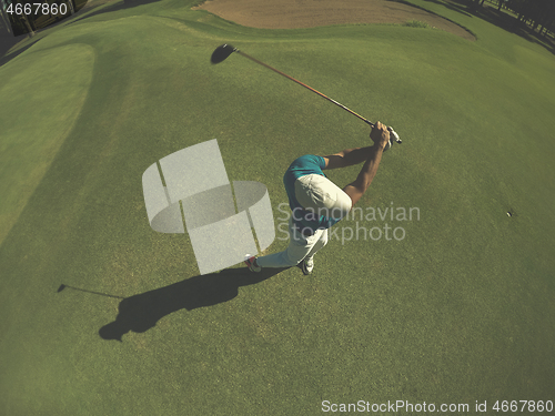 Image of top view of golf player hitting shot