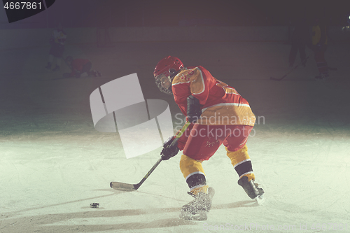 Image of teen ice hockey player in action