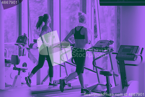 Image of woman exercising on treadmill in gym