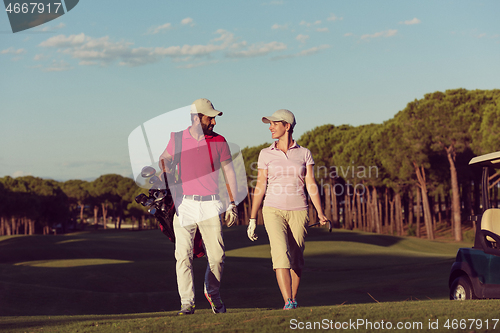 Image of couple walking on golf course