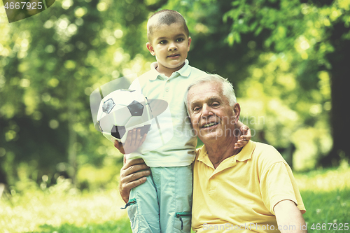 Image of grandfather and child have fun  in park