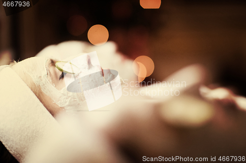 Image of woman in spa  with cosmetic mask