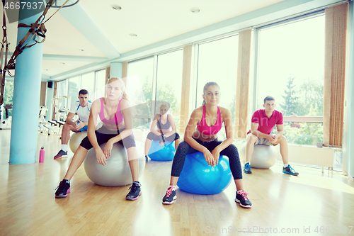 Image of group of people exercise with balls on yoga class