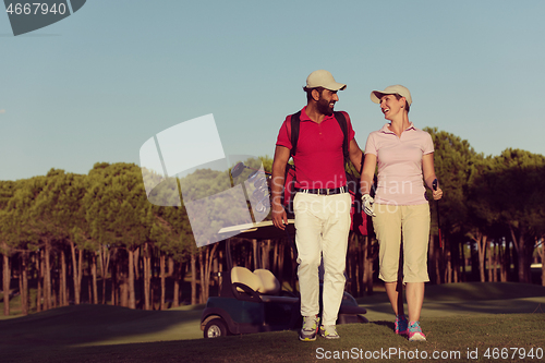 Image of couple walking on golf course