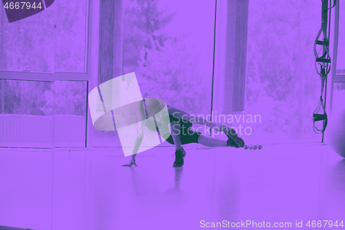 Image of woman stretching and warming up for her training at a gym