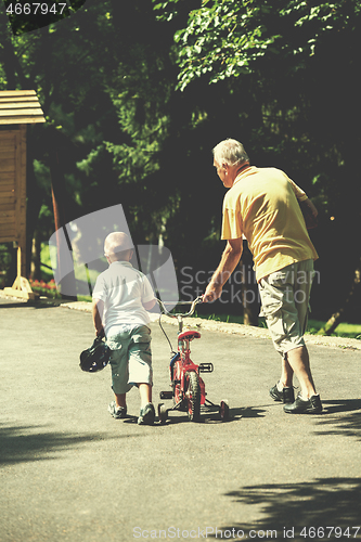 Image of grandfather and child have fun  in park