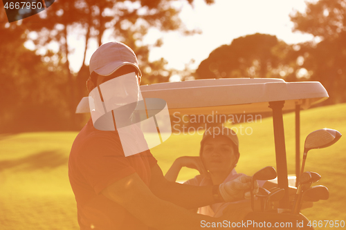 Image of couple in buggy on golf course