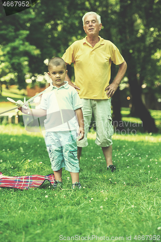 Image of grandfather and child have fun  in park