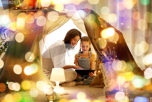 Image of family with tablet pc in kids tent at home