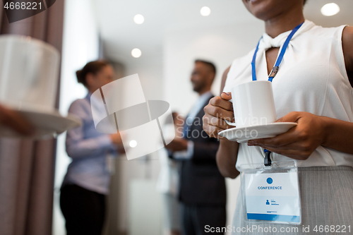 Image of business people with conference badges and coffee