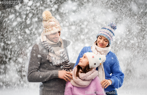 Image of happy family in winter clothes on snow background