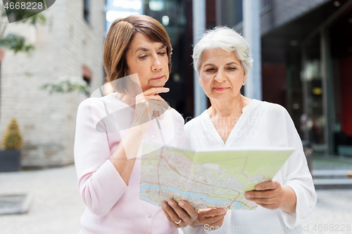 Image of senior women with city map on street in tallinn