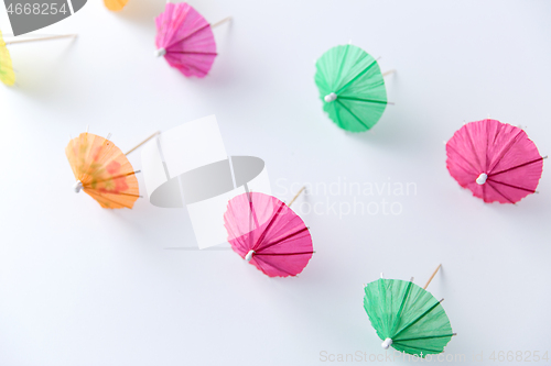 Image of cocktail umbrellas on white background