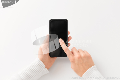 Image of close up of hands with black smartphone