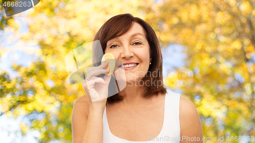 Image of woman cleaning face with exfoliating sponge