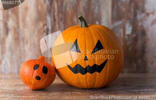 Image of halloween pumpkin and squash on wooden background