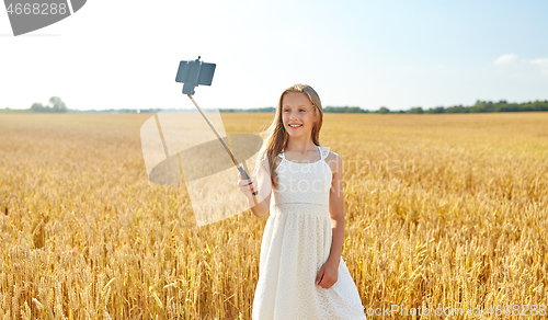 Image of happy young girl taking selfie by smartphone