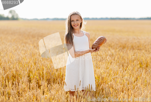 Image of girl with loaf of white bread on cereal field