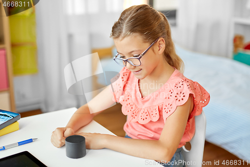 Image of student girl using smart speaker at home